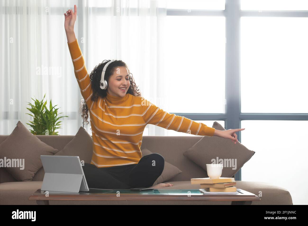 Girl sitting arms legs crossed hi-res stock photography and images - Alamy