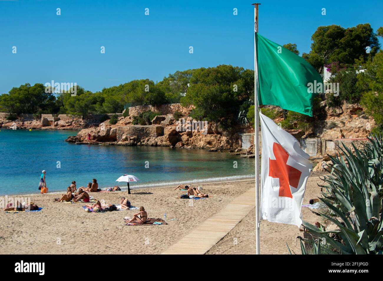 Cala Gracioneta, Ibiza - September 28, 2020 Green flag on the beach of Cala Gracioneta, Ibiza. It indicates the good state of the sea and that bathing Stock Photo