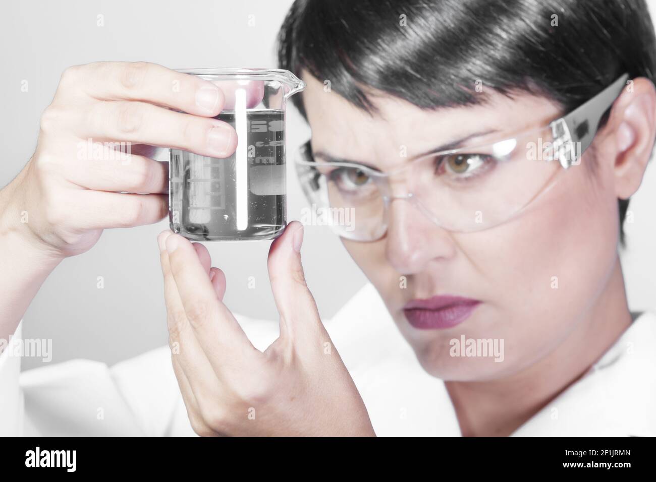 Portrait of happy young attractive smiling woman scientist with protective eyeglasses in the scientific chemical laboratory Stock Photo