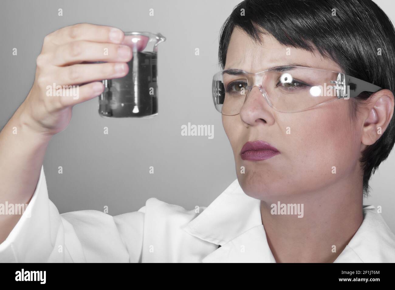 Portrait of happy young attractive smiling woman scientist with protective eyeglasses in the scientific chemical laboratory Stock Photo