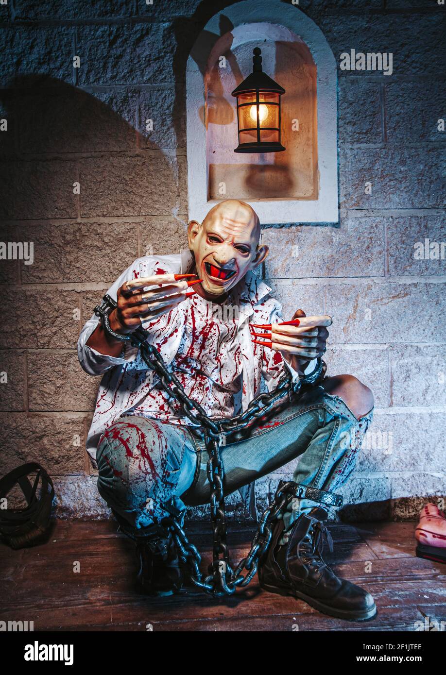 Halloween costume, Man chained with blood and knife, Zombie man death the ghost horror drain hand blood skin is screaming darkne Stock Photo