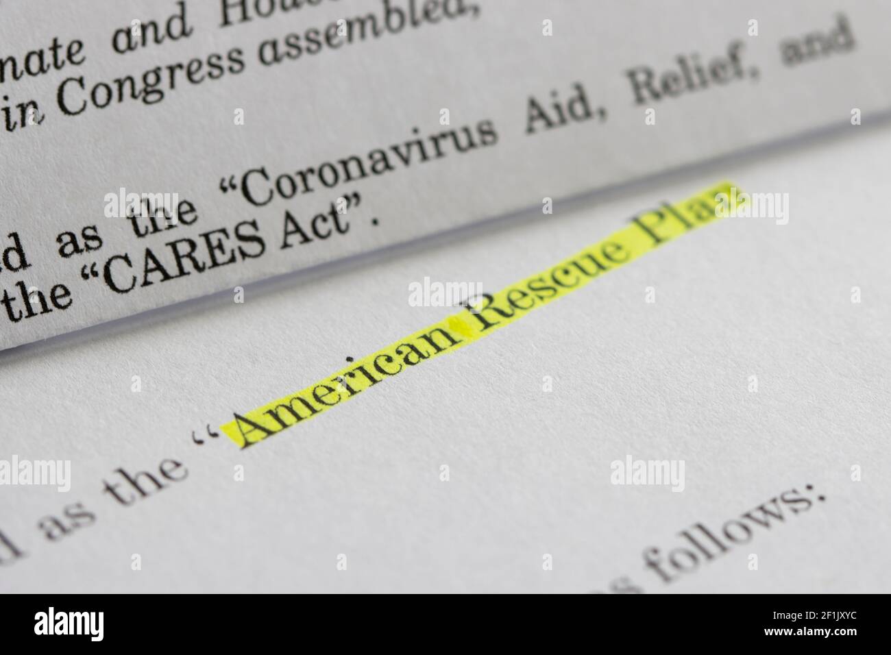 Closeup of the documents of both the Cares Act (Coronavirus Aid, Relief, and Economic Security Act) and the American Rescue Plan Act of 2021. Stock Photo