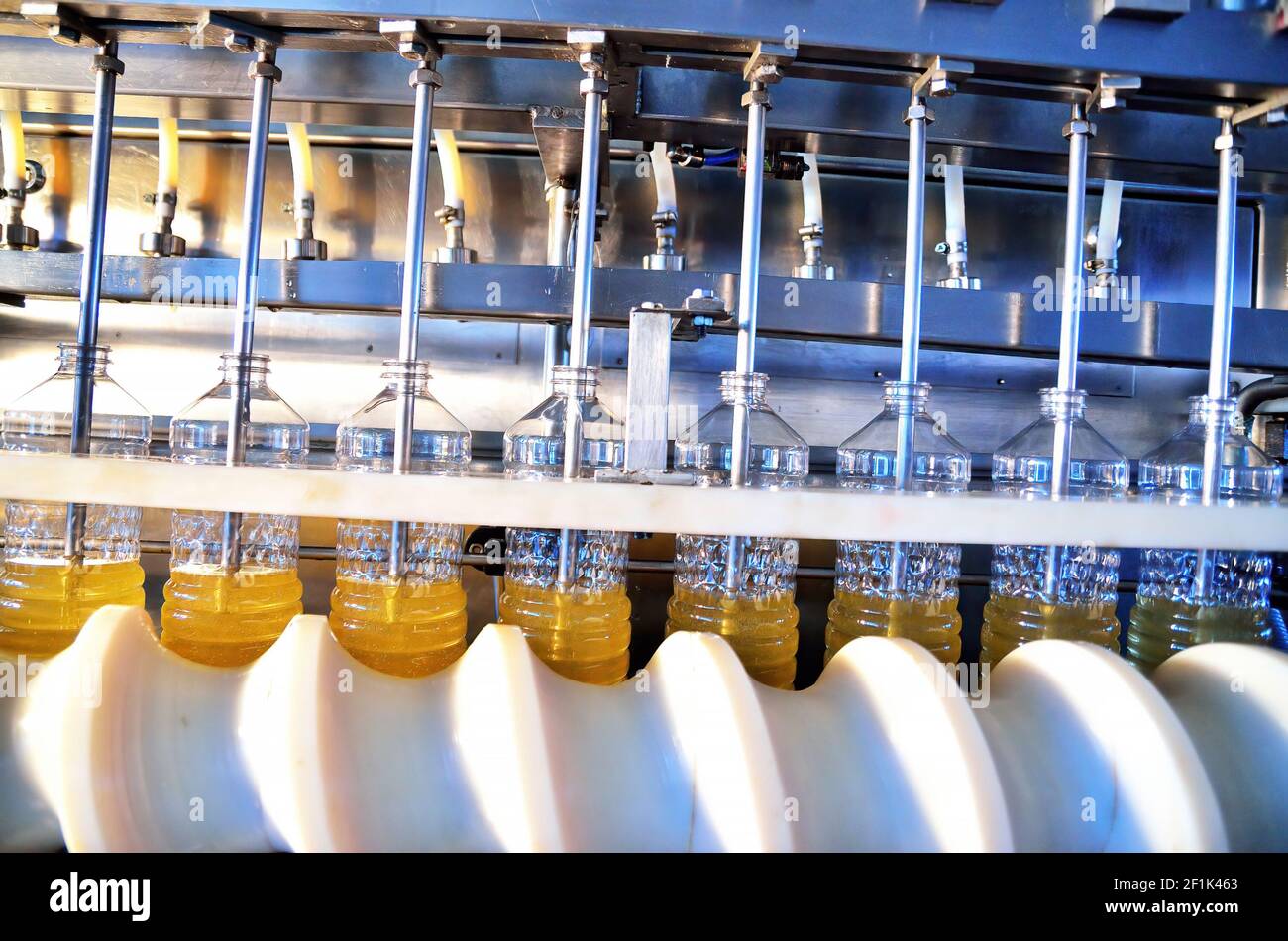 Sunflower oil. Factory line of production and filling of refined oil from sunflower seeds. Factory conveyor of food industry Stock Photo