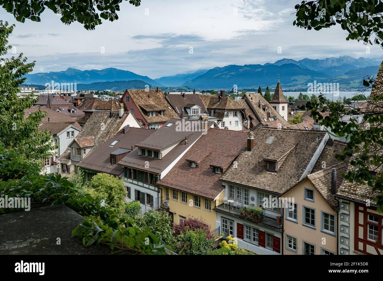 A view from above of the historic old town of Rapperswil framed by lush ...