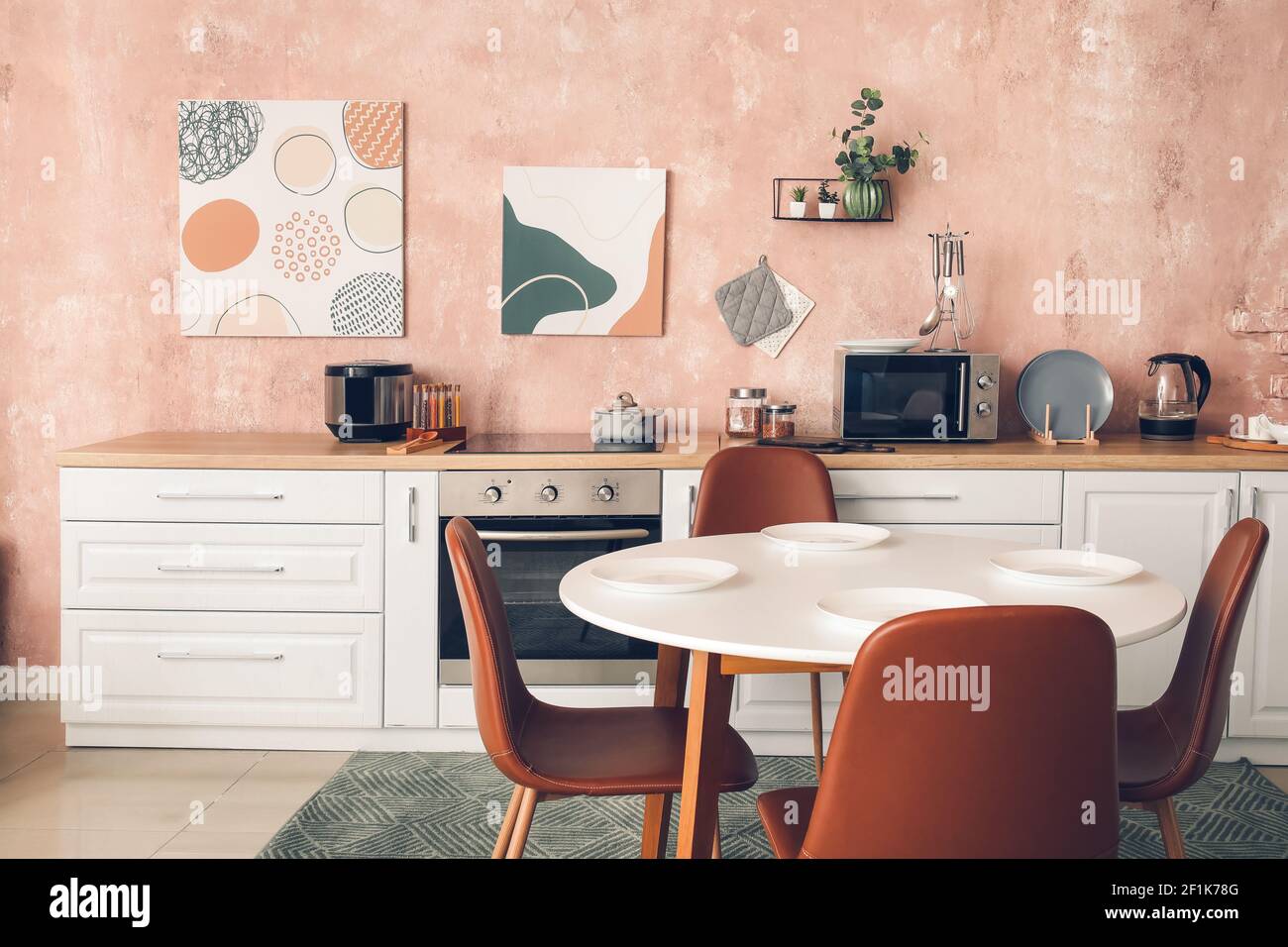 Stylish interior of modern kitchen with dining table Stock Photo - Alamy