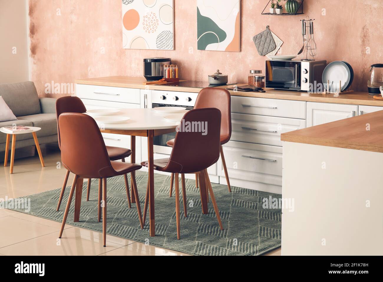 Stylish interior of modern kitchen with dining table Stock Photo - Alamy