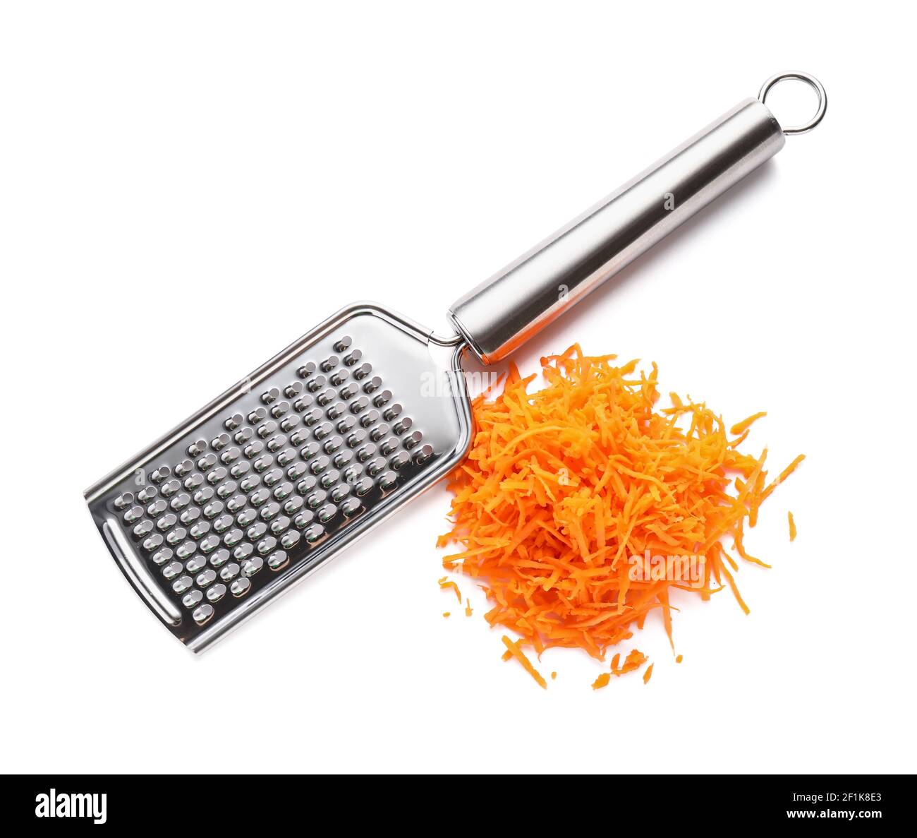 Metal grater and carrot on white background Stock Photo - Alamy