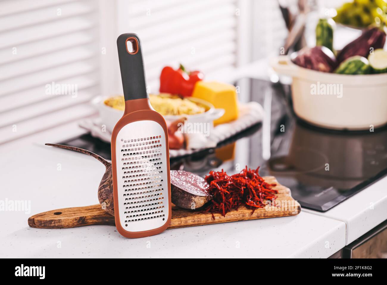 Fresh beetroot and grater on kitchen table Stock Photo