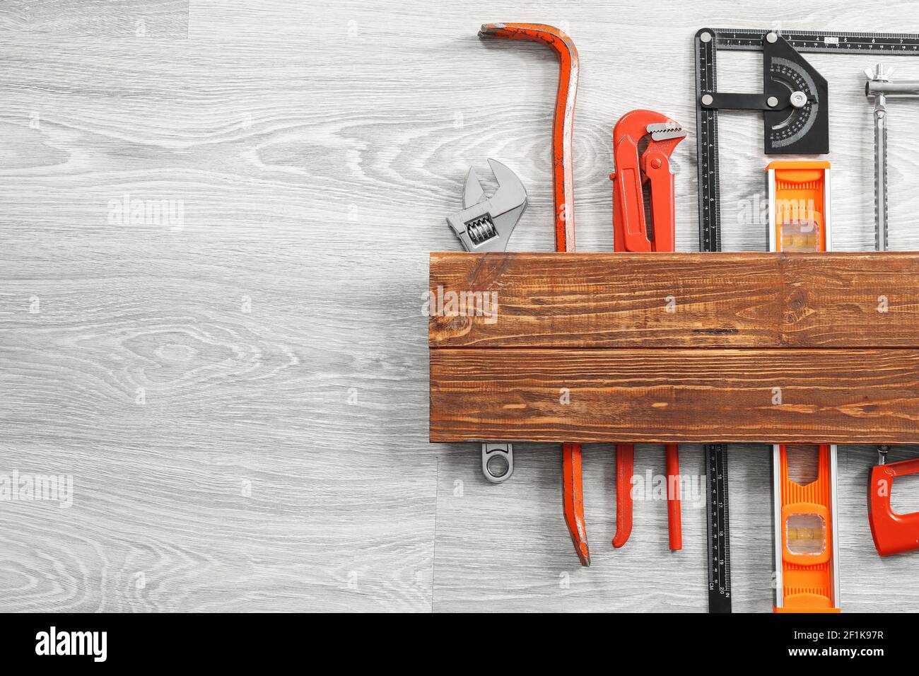 Set of construction tools on grey wooden background Stock Photo - Alamy
