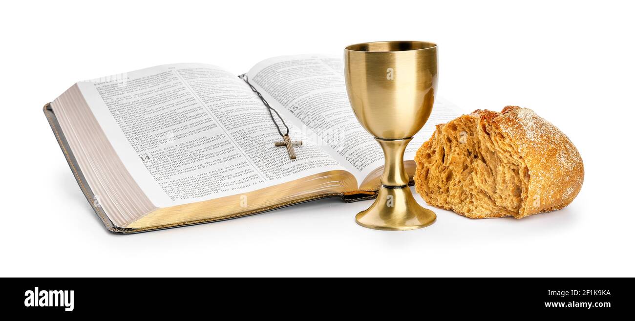 Holy Bible with bread and chalice of wine on white background Stock