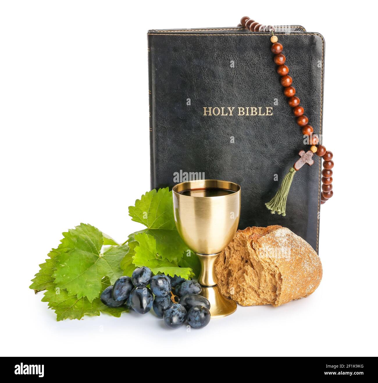 Holy Bible with bread and chalice of wine on white background Stock