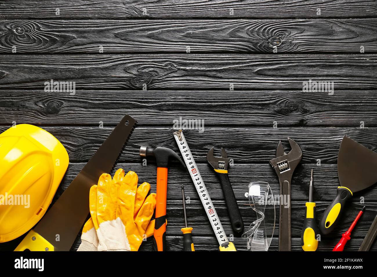 Set of construction tools on dark wooden background Stock Photo - Alamy