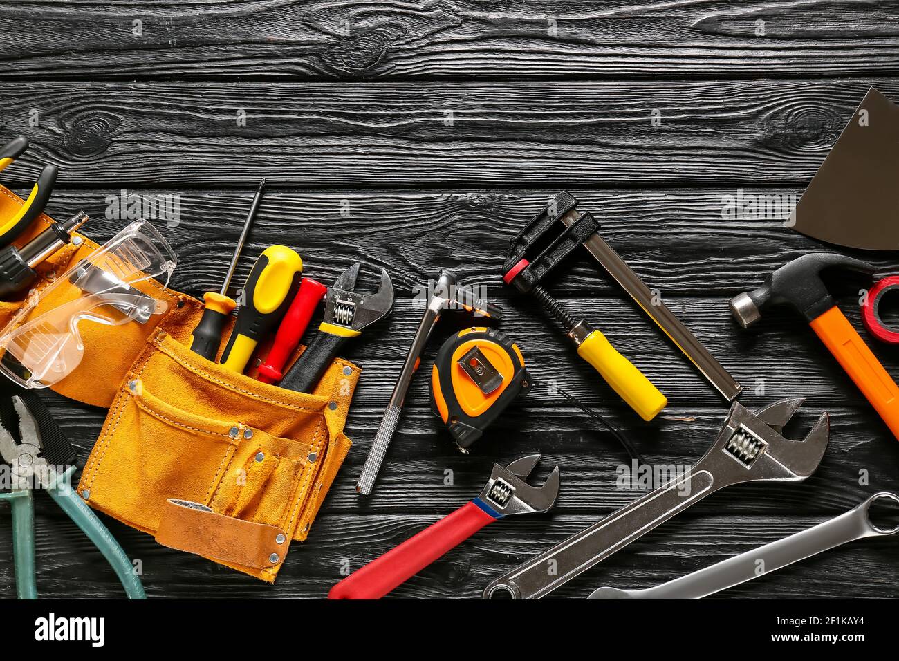 Set of construction tools on dark wooden background Stock Photo - Alamy