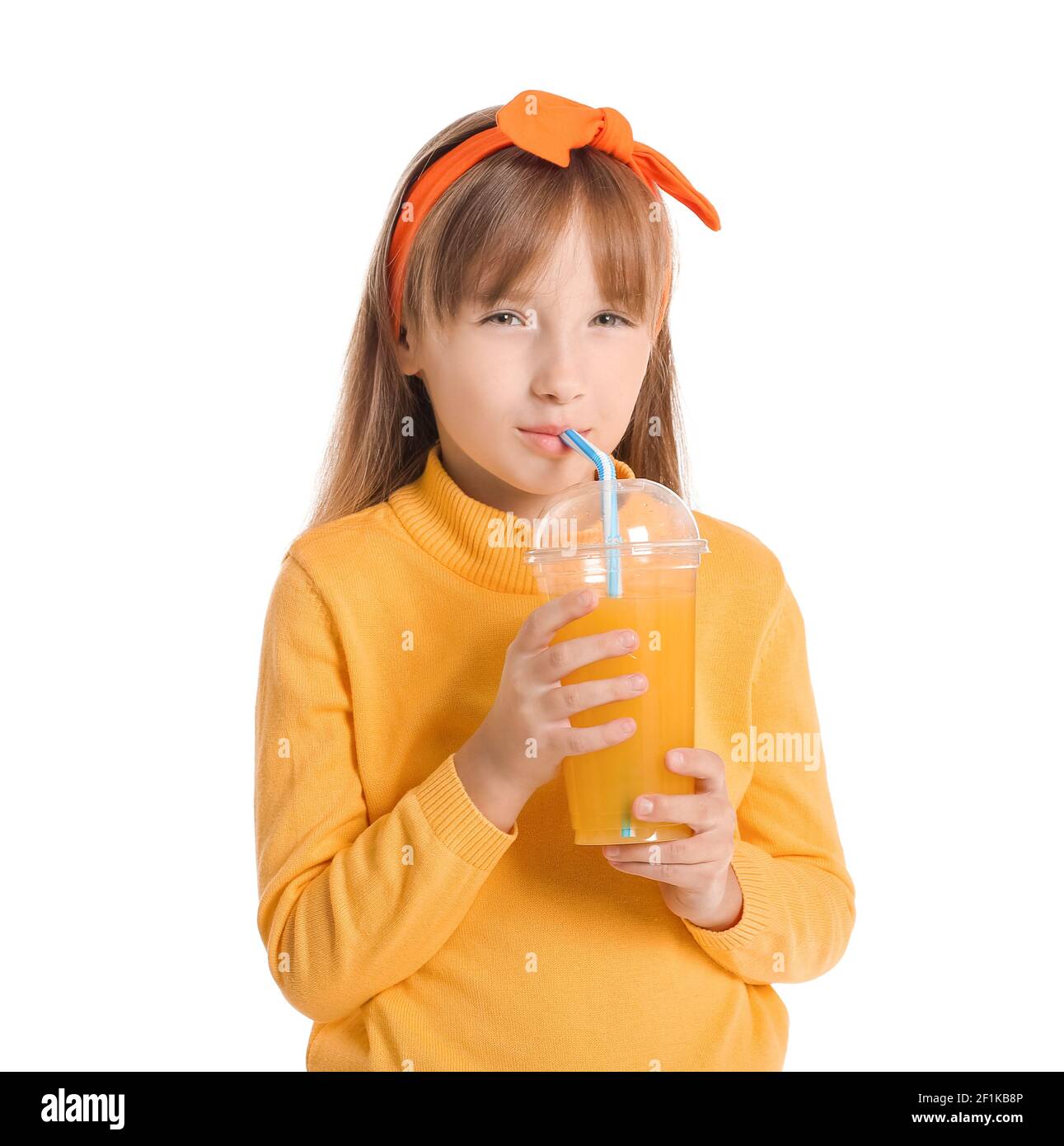 Cute little girl drinking orange juice on white background Stock Photo ...