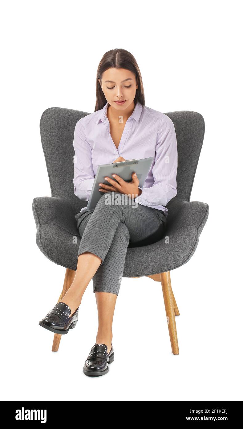 Portrait of female psychologist sitting in armchair on white background