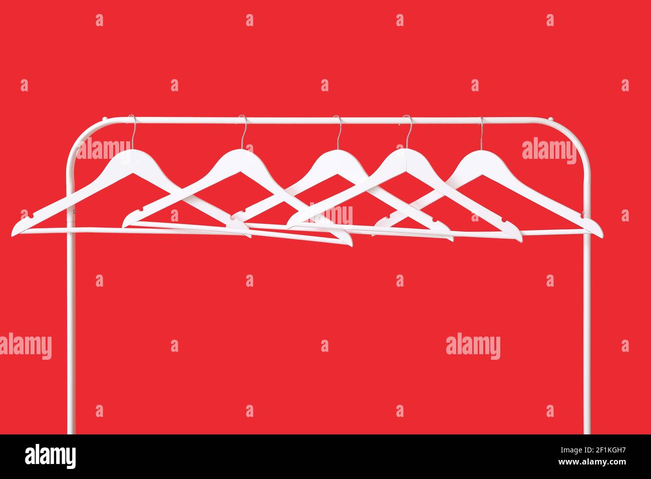 Rack with clothes hangers on color background Stock Photo - Alamy