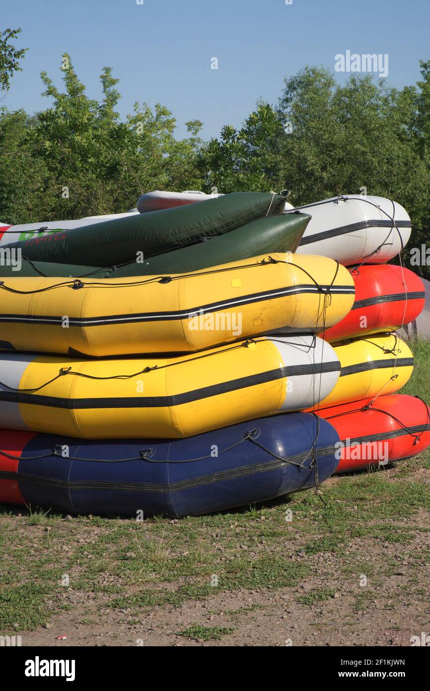 Multicolored rafting boats stacked on top of each other Stock Photo