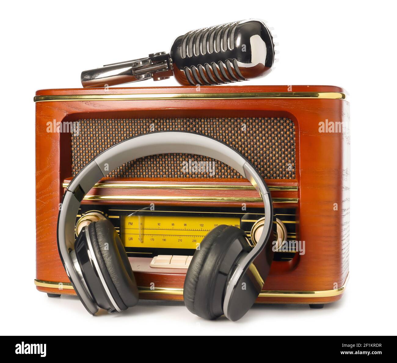 Retro radio receiver with microphone and headphones on white background