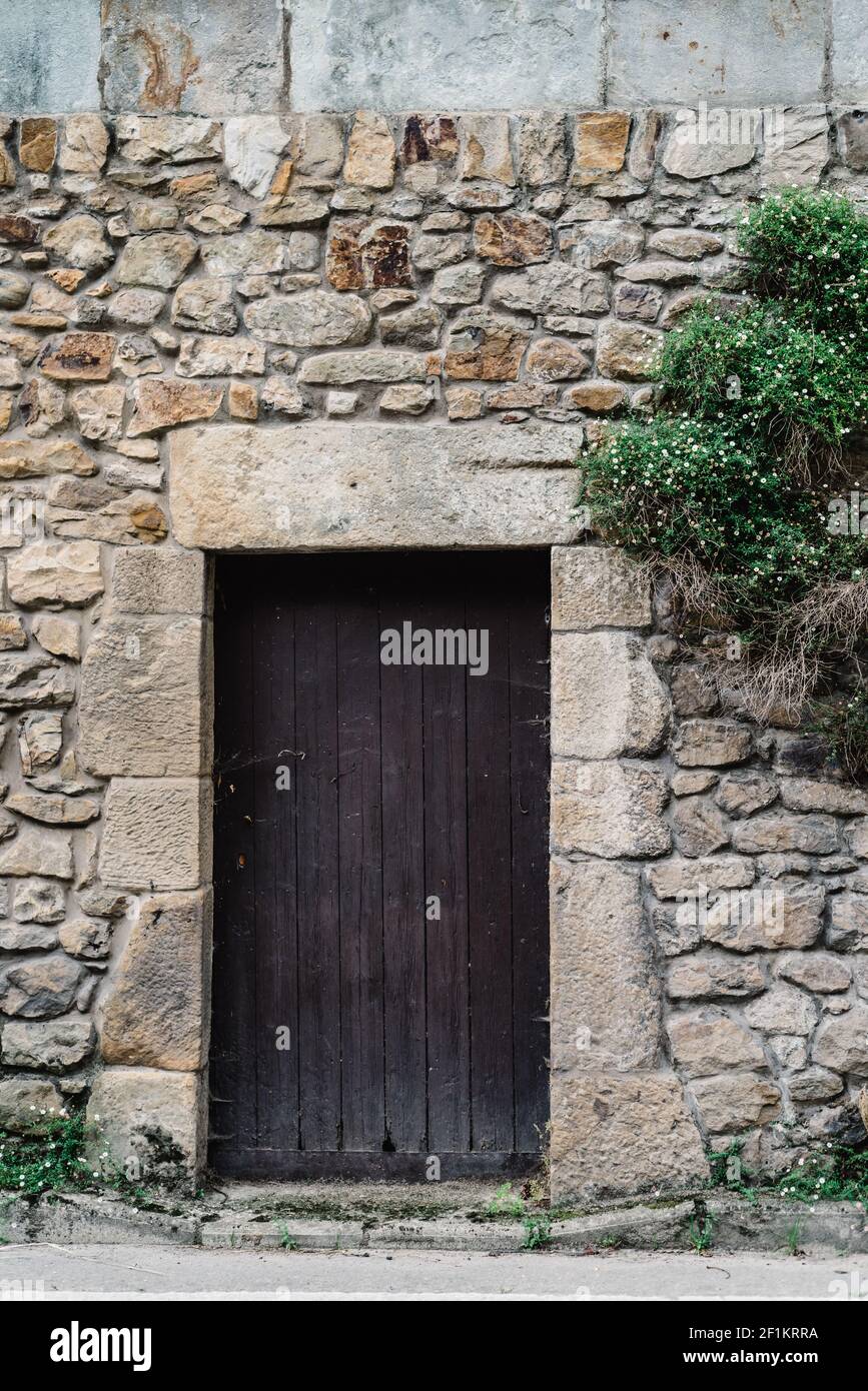Old wooden door in masonry stone wall Stock Photo - Alamy