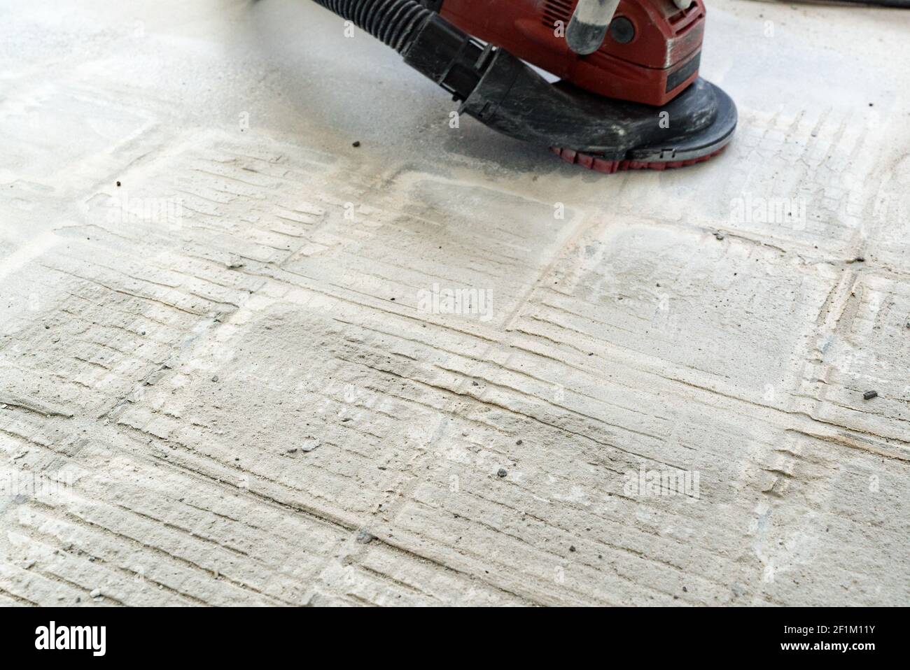 Angle grinder to remove outlet glue from concrete