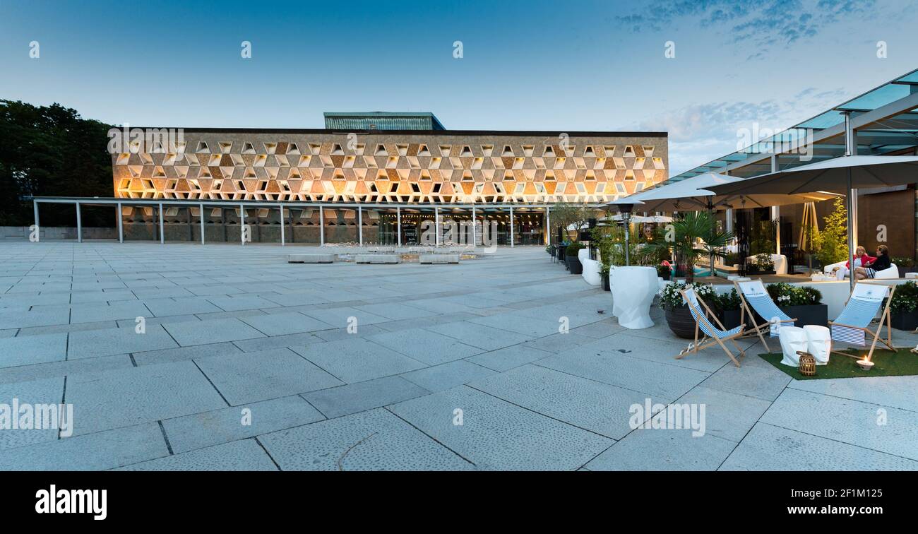 Panorama view of the Grand Theater in Luxembourg City at sunset with people having drinks in the the Stock Photo