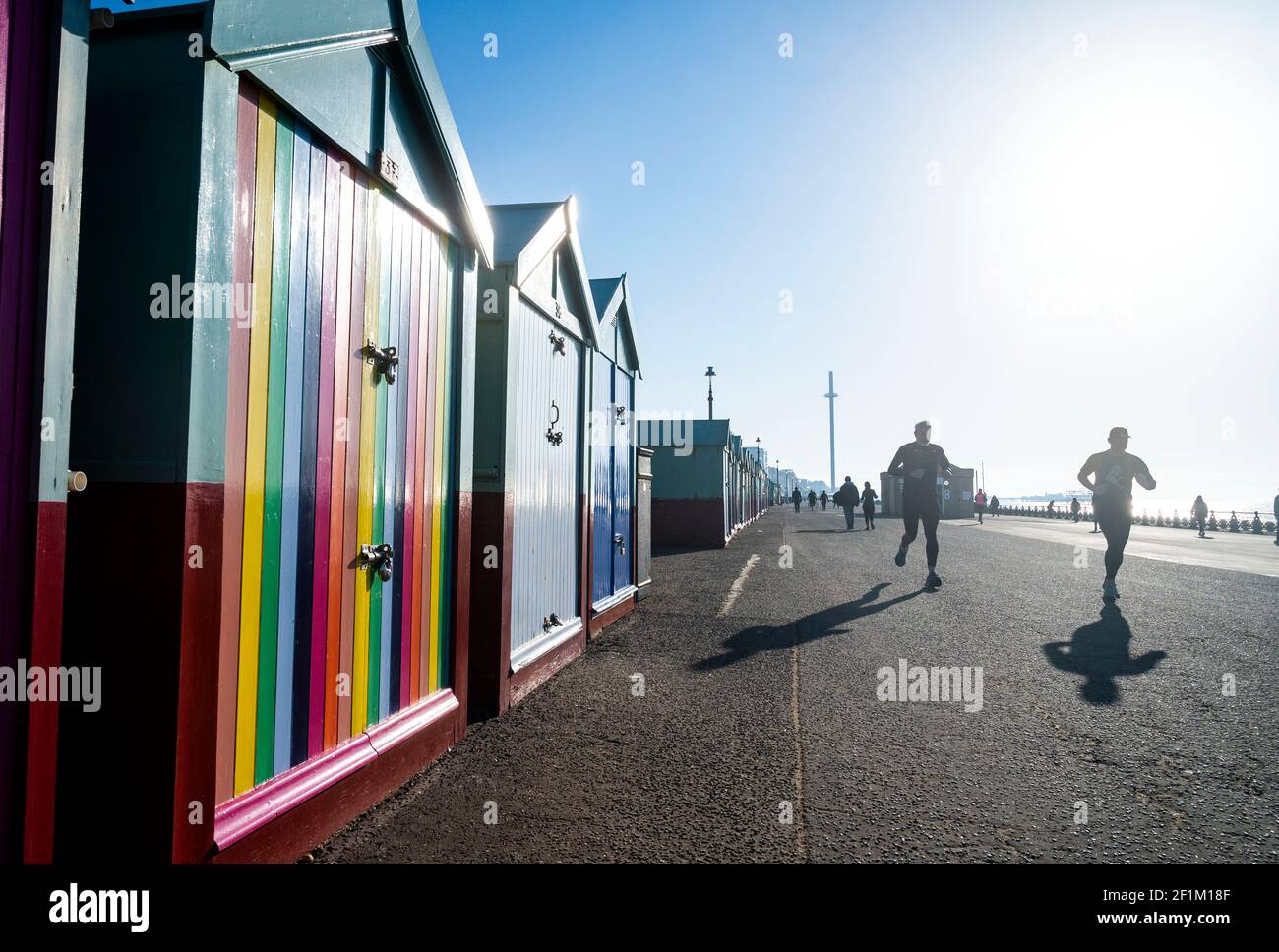 Brighton UK 9th March 2021 - Runners make the most of a beautiful sunny morning along Hove seafront as wet and stormy weather is forecast to arrive in the next few days throughout Britain : Credit Simon Dack / Alamy Live News Stock Photo