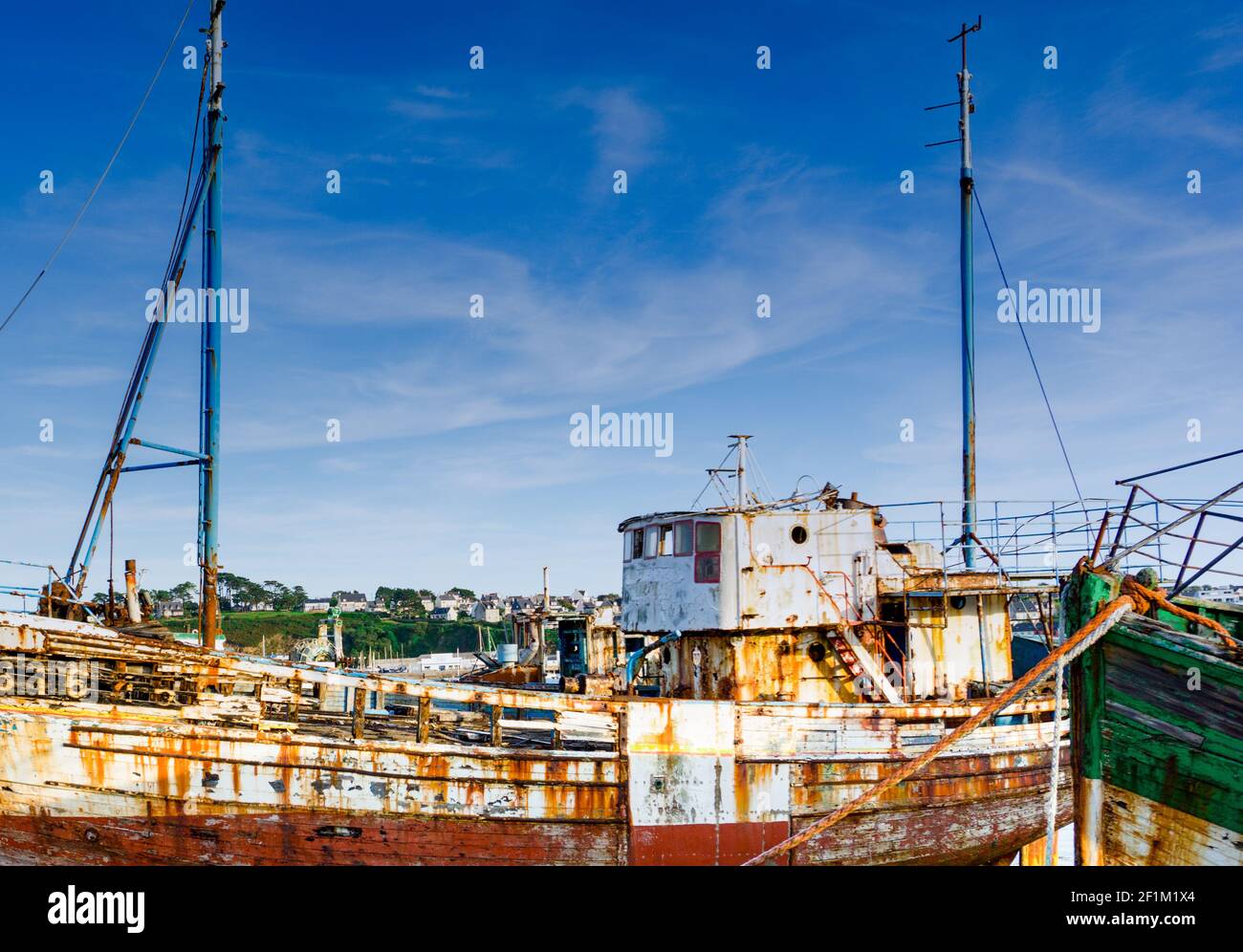 Old fishing boat wrecks stranded and left on a rocky beach Stock Photo ...