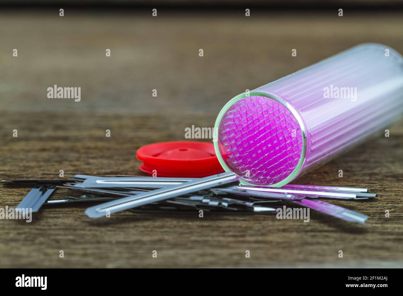 Close up capillary tube with blood lancet , Medical equipment on wooden