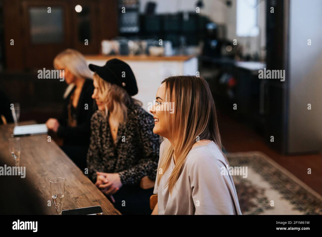 Young woman sitting in cafe Stock Photo - Alamy