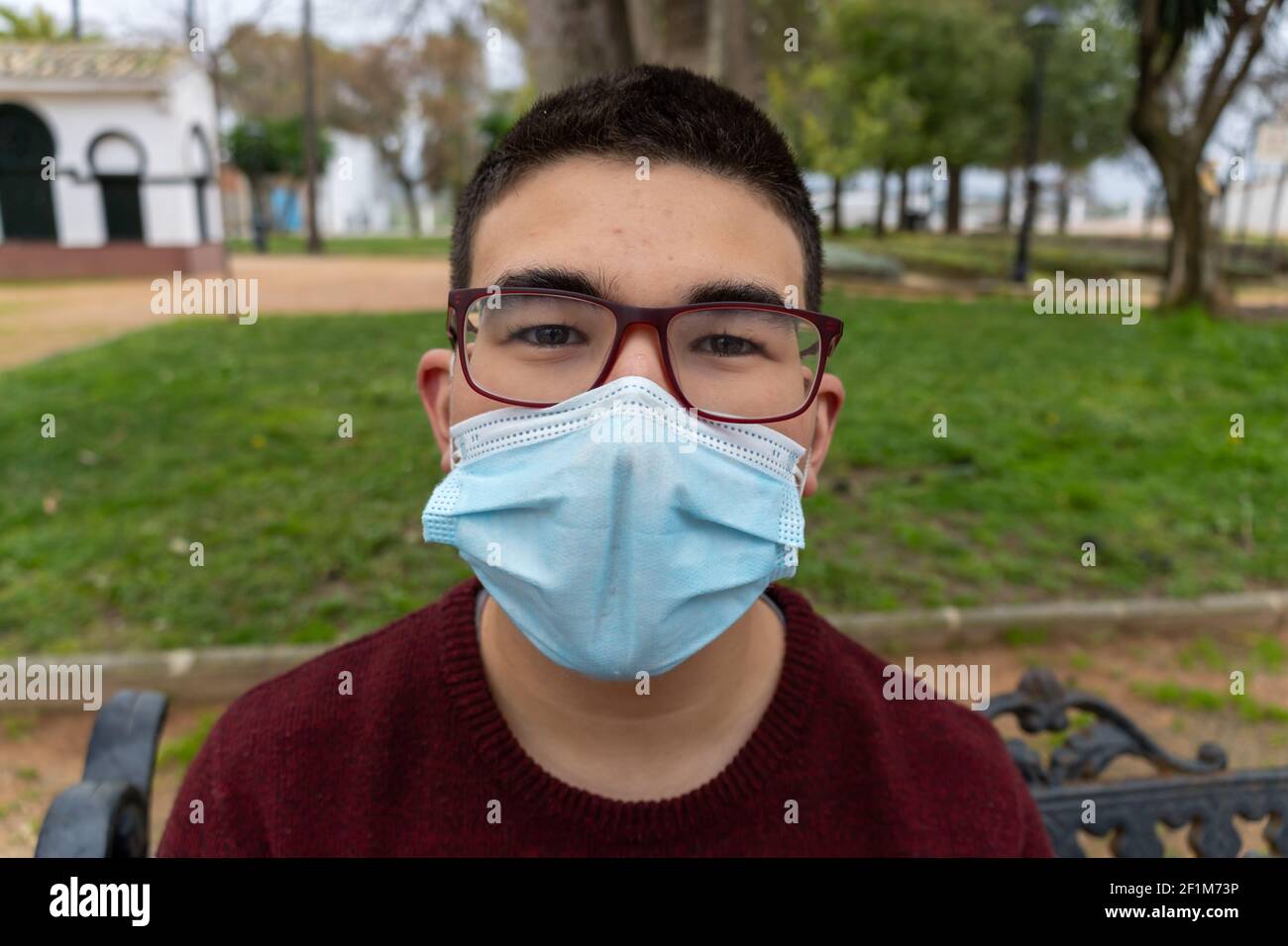 Stock photo of young boy wearing face mask due covid19 looking at ...