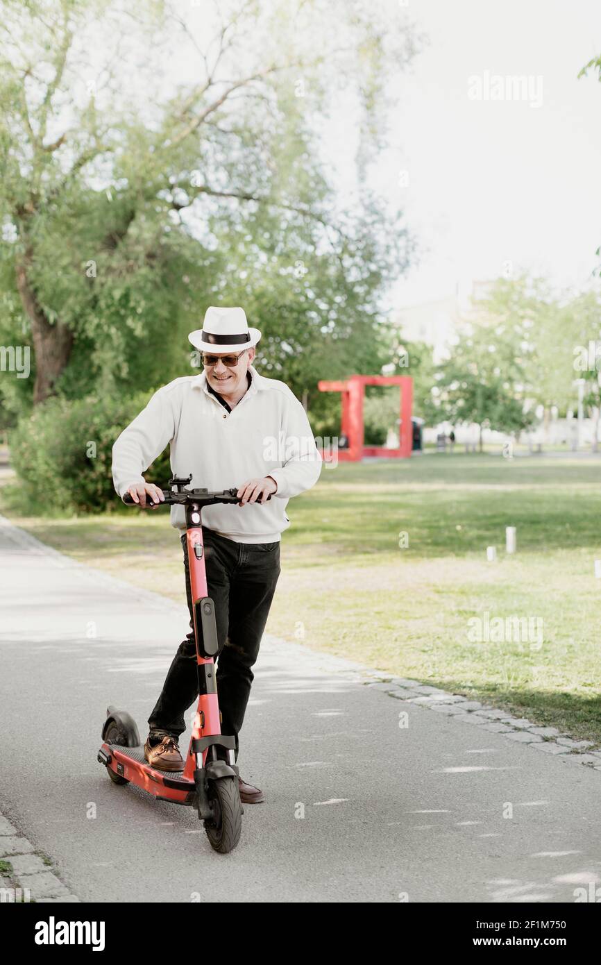 Man riding electric scooter hi-res stock photography and images - Alamy