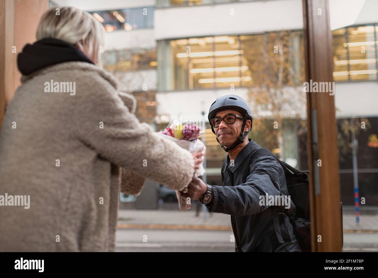 Bicycle courier delivering flowers Stock Photo