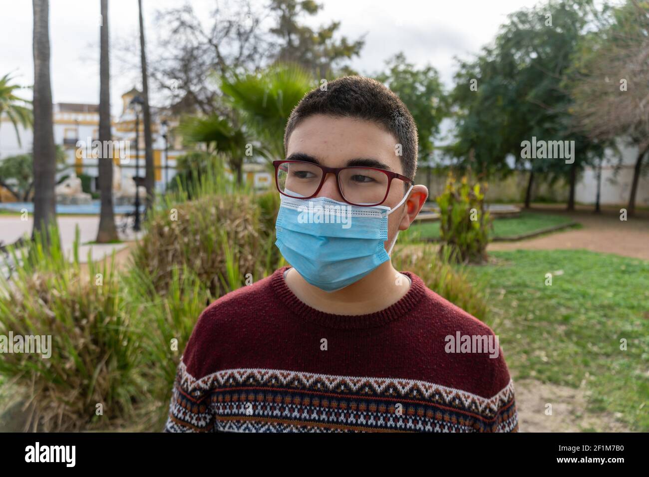 Stock photo of young boy wearing face mask due covid19 looking at ...