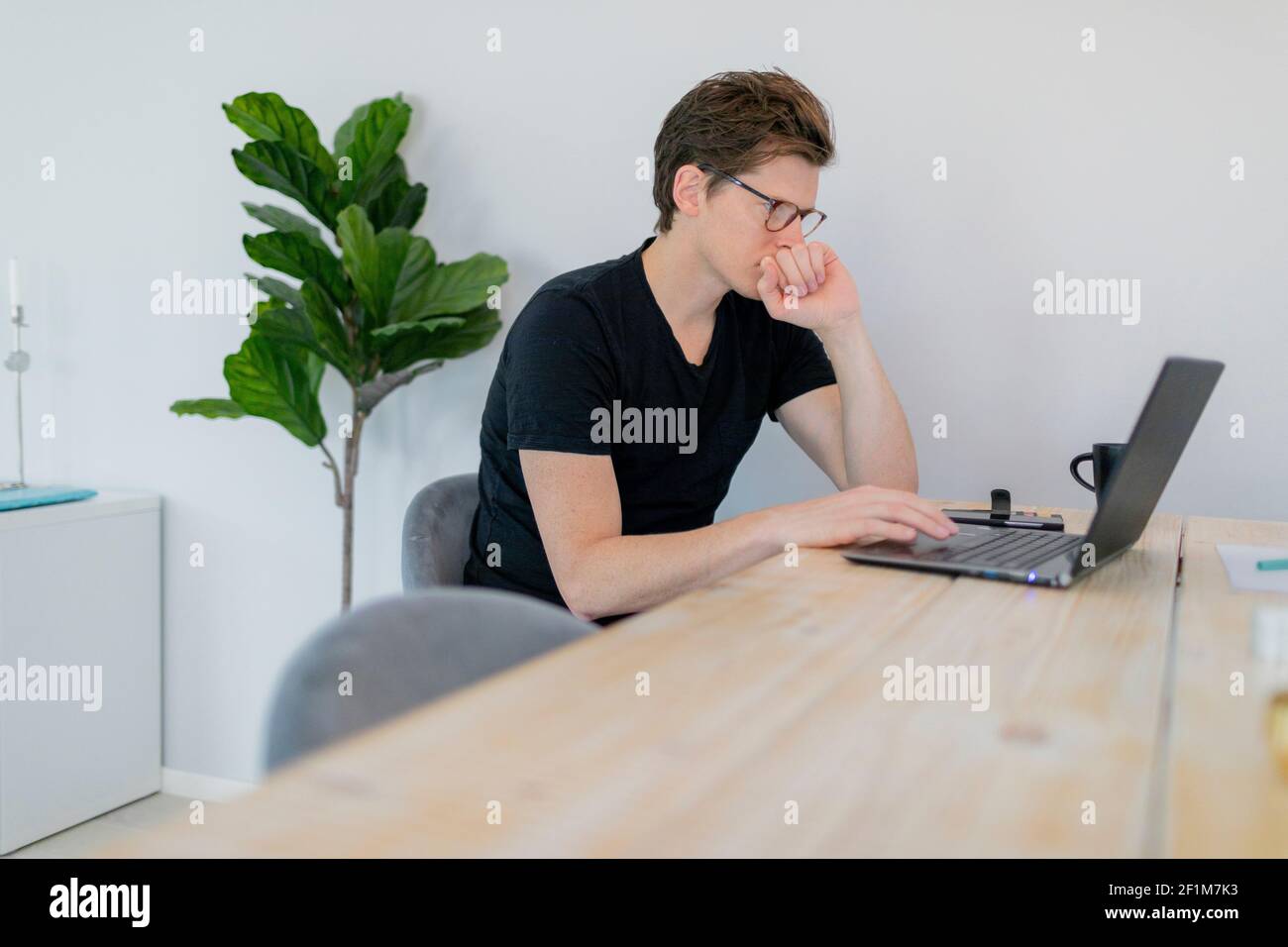 Man using laptop at home Stock Photo