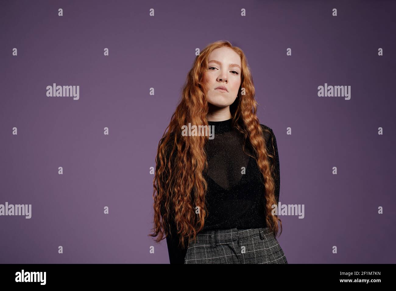 Woman looking at camera, studio shot Stock Photo