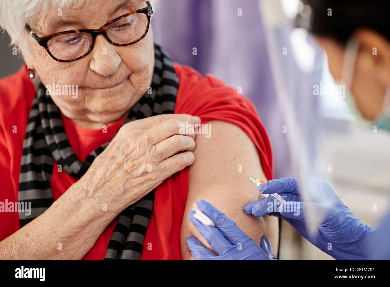 Senior woman getting covid vaccine Stock Photo
