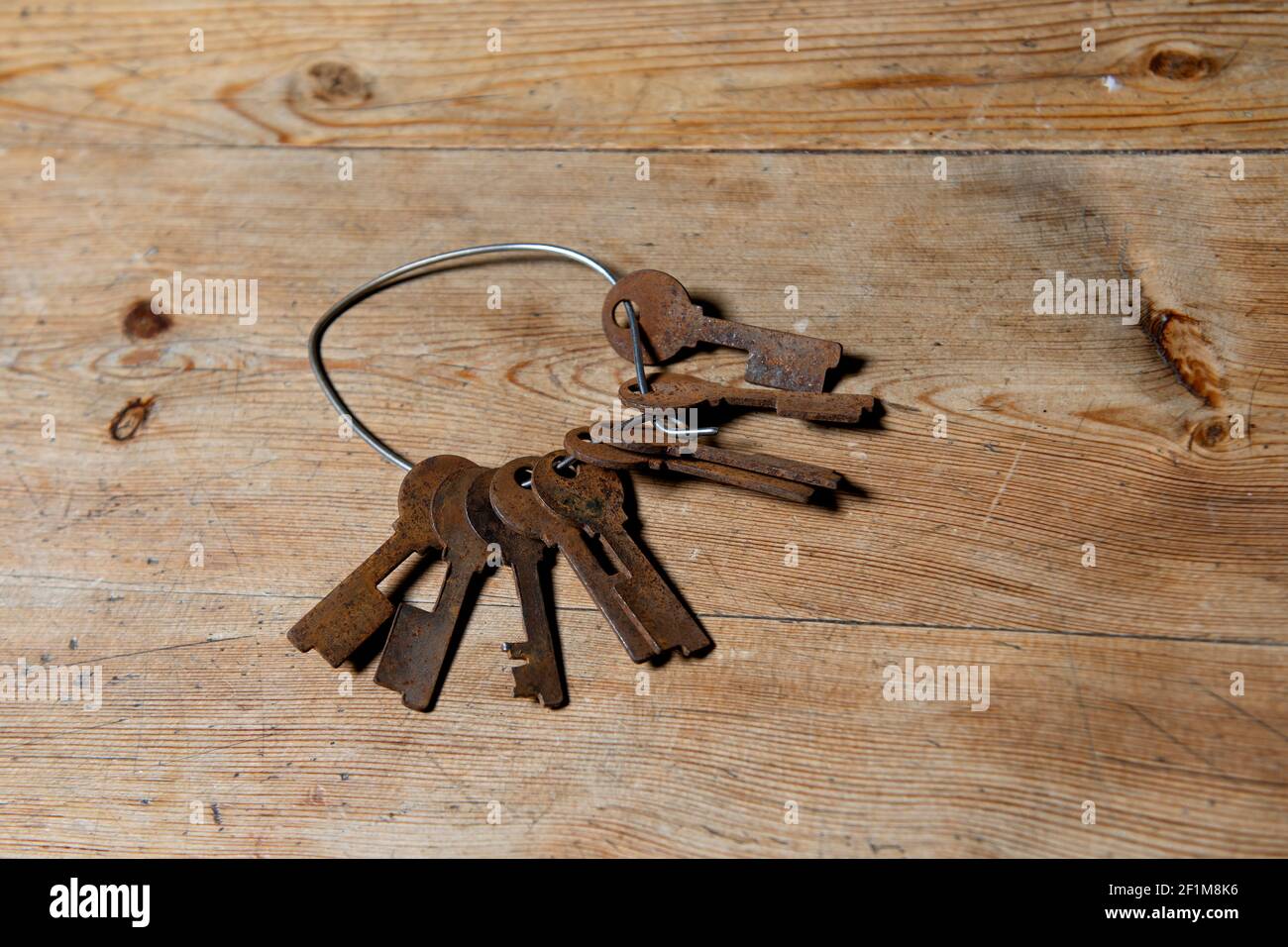 Rusty keys on wooden background Stock Photo
