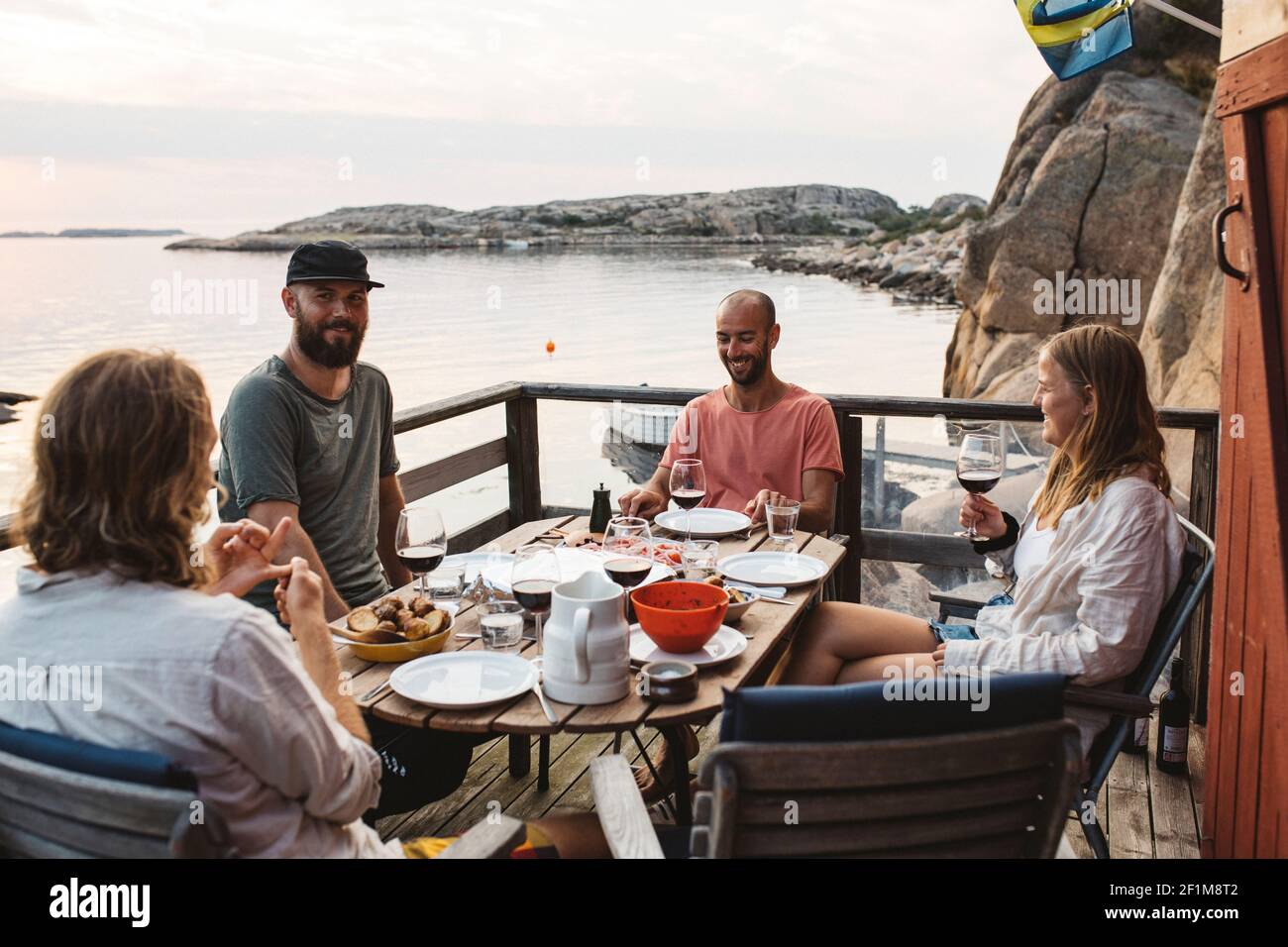 Friends having meal on patio Stock Photo