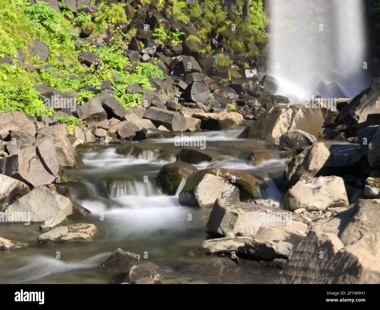 Smooth Stream Rocks A mesmerizing view of rocks in a stream with smooth flowing water in ...