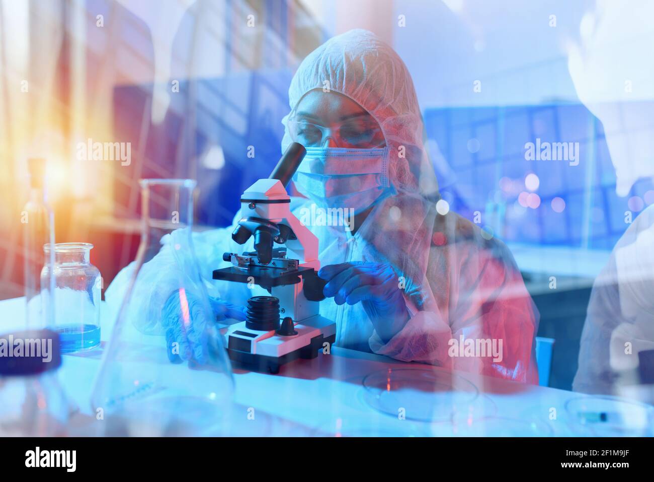 Doctor in the laboratory analyzes samples under a microscope. Pharmaceutical treatment concept. Stock Photo
