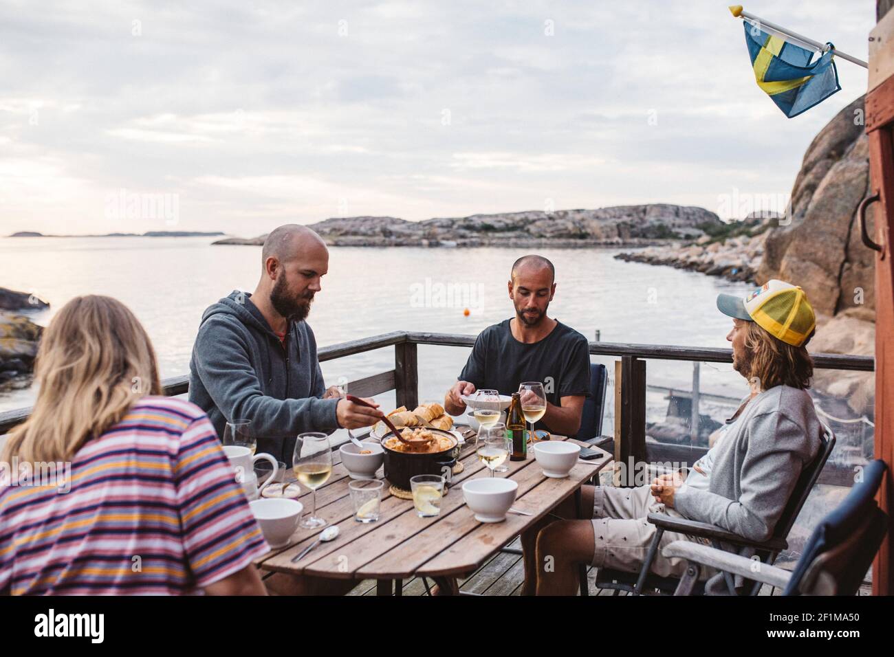 Friends having meal on patio Stock Photo