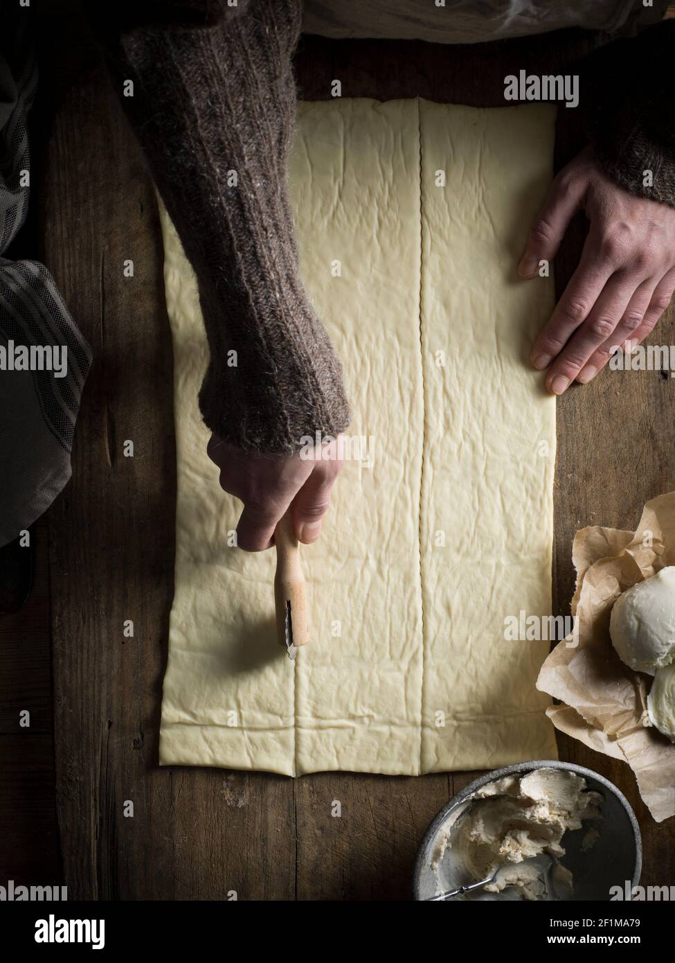 Hands cutting dough using pasta cutter wheel Stock Photo Alamy