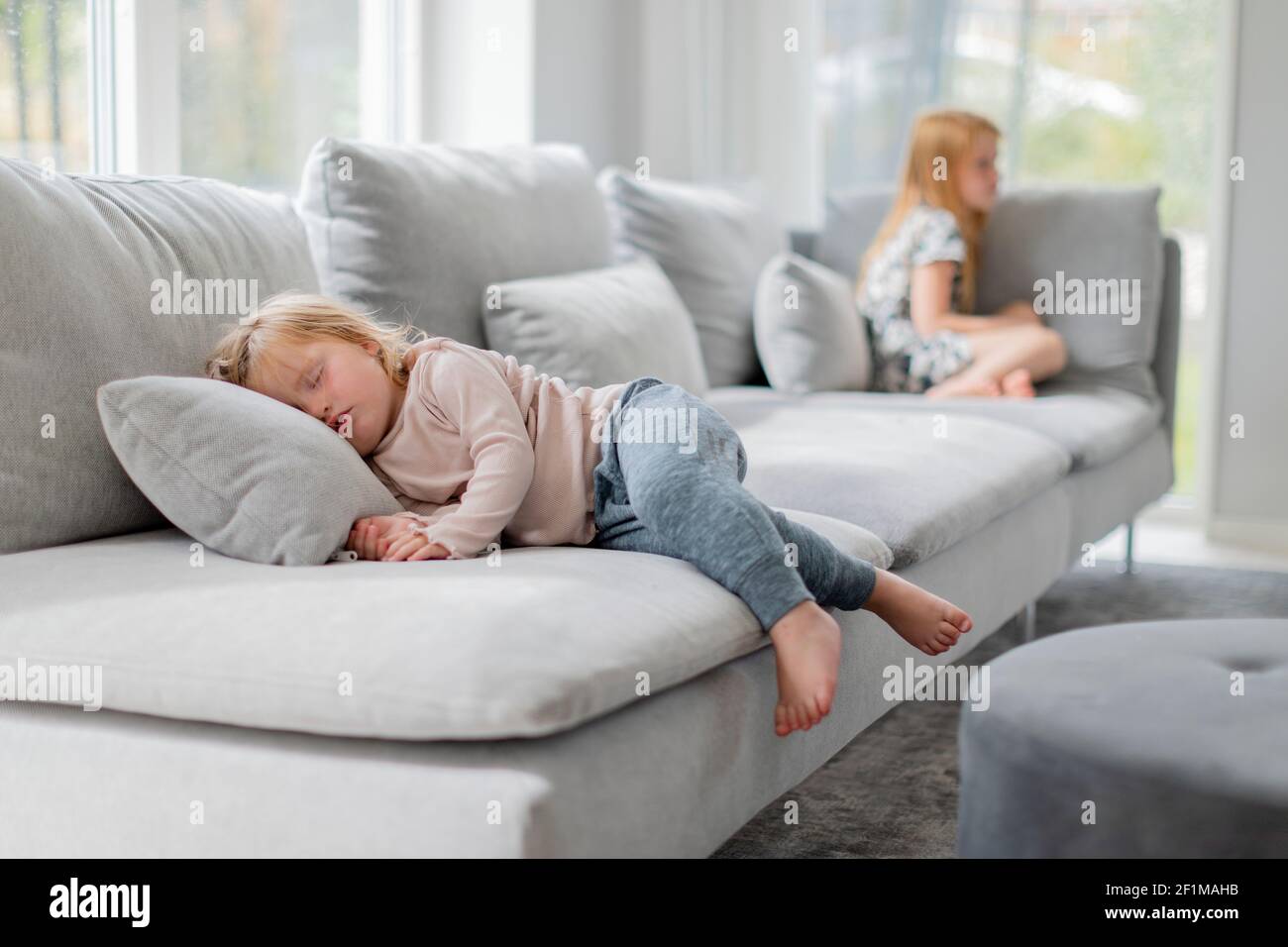 Toddler girl sleeping on sofa Stock Photo Alamy