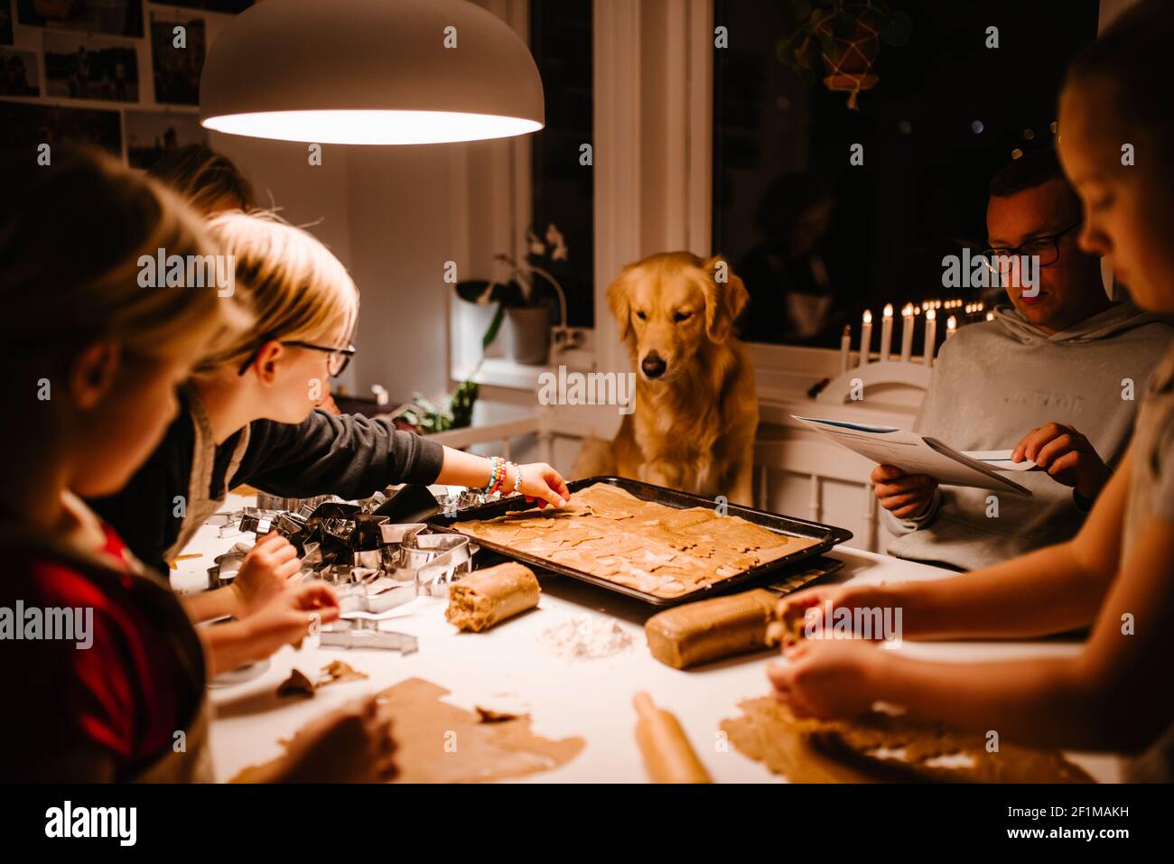 Family at table preparing gingerbread Stock Photo
