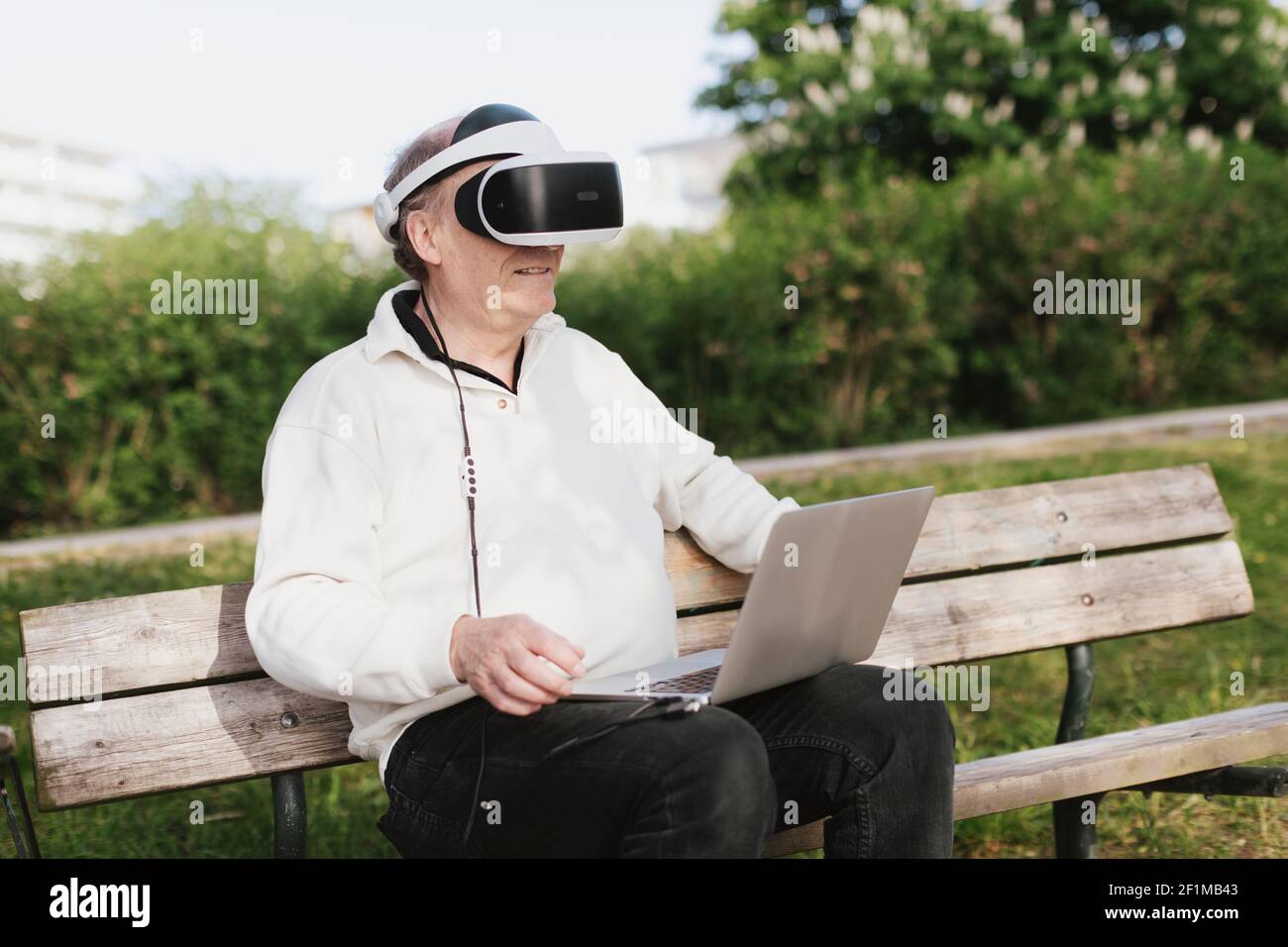 Man in park using VR headset Stock Photo