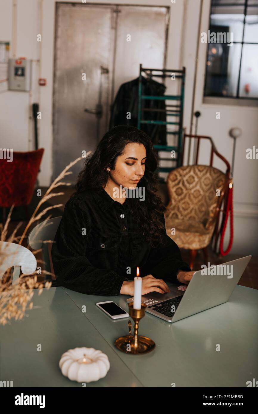 Young woman using laptop in cafe Stock Photo
