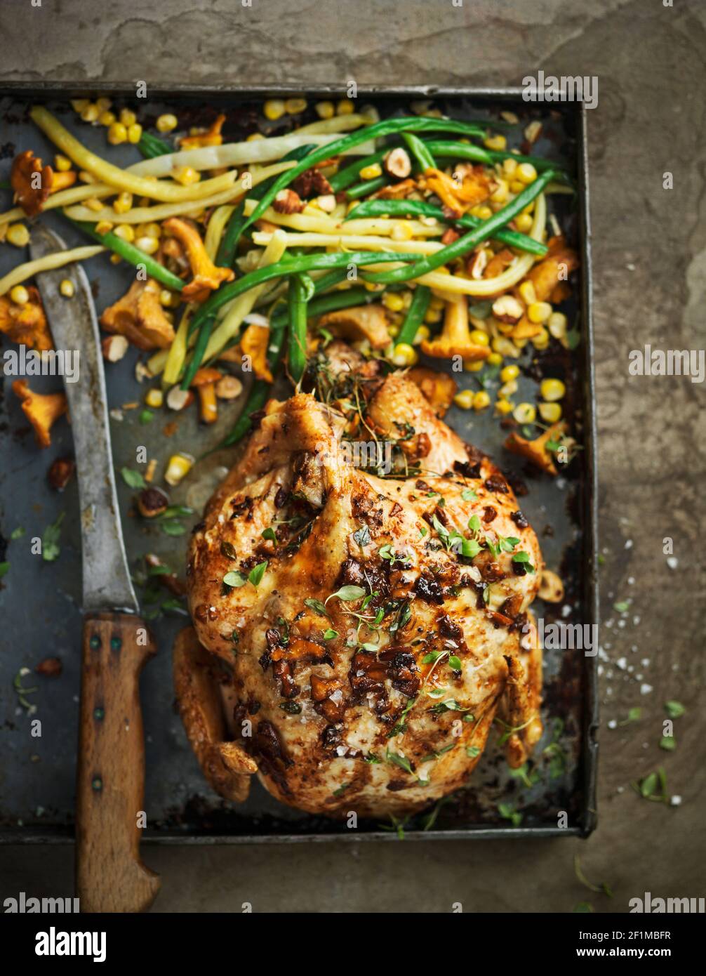 Roasted chicken with vegetables on baking tray Stock Photo