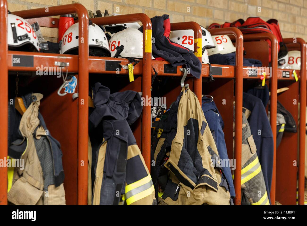 Firefighters uniforms in locker Stock Photo - Alamy