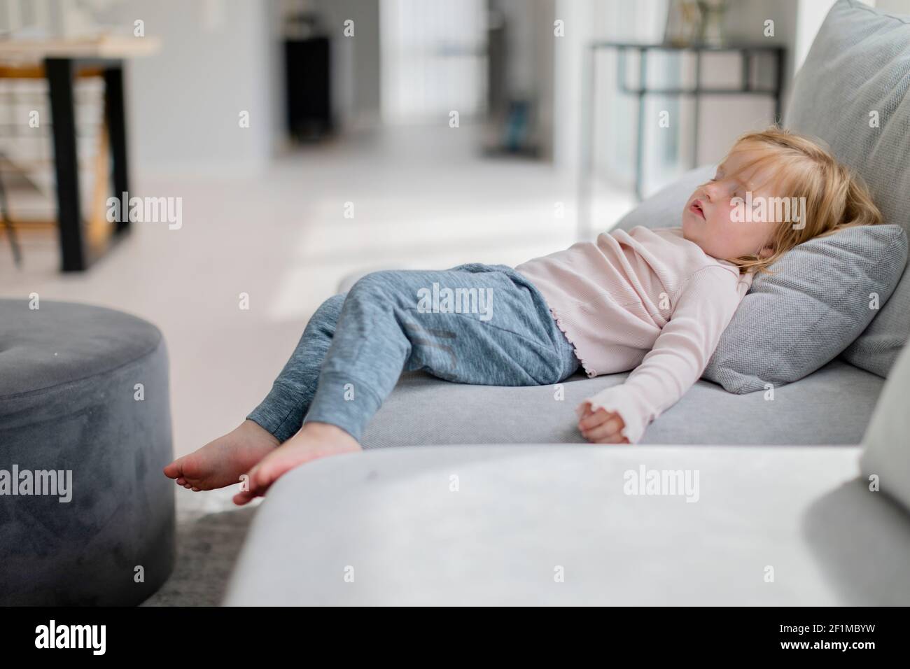 Toddler girl sleeping on sofa Stock Photo Alamy