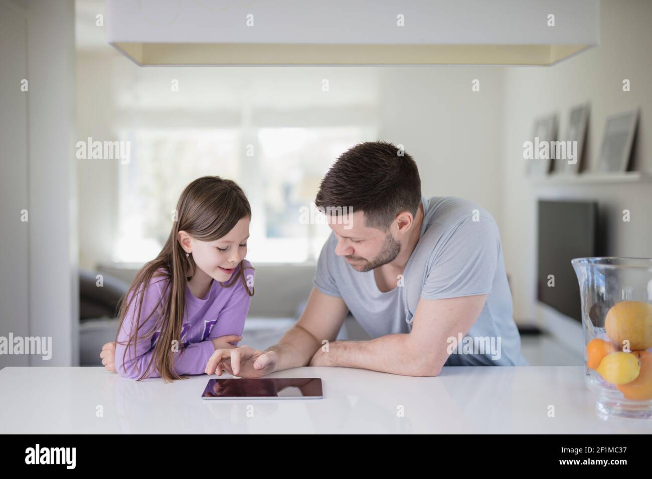 Father and daughter using digital tablet Stock Photo